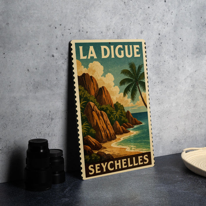 A vintage-style poster of La Digue, a tropical island in the Seychelles, featuring a palm tree and a rocky coastline.