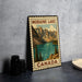 A vintage-style metal sign with a mountain landscape and a lake, featuring the text "MORaine Lake Canada" on it.