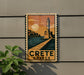 A vintage-style sign depicting a lighthouse and a coastal scene, with the text "CRETE GREECE" prominently displayed.