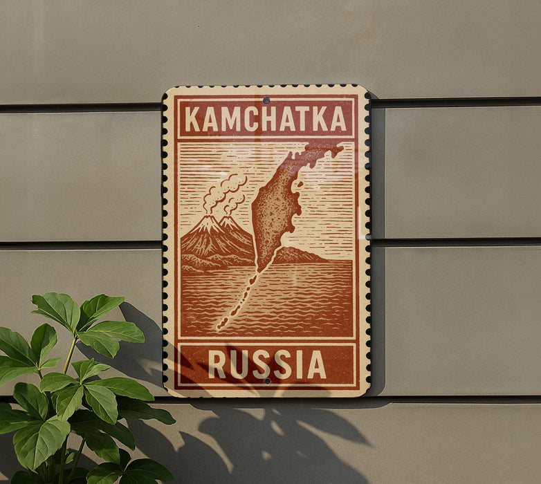 a sign that reads "KAMCHATKA RUSSIA" with a map of Russia and a mountain range.