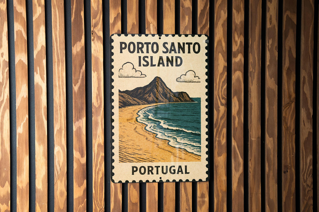 A vintage-style metal sign with the text "PORTO SANTO ISLAND" and an illustration of a beach and mountains, mounted on a wooden wall.