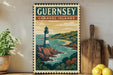 A vintage-style poster of Guernsey Channel Islands, featuring a lighthouse and a coastal landscape, is displayed on a wall next to a wooden cutting board and a potted plant.