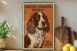 a framed stamp-like artwork of an English Springer Spaniel dog, with a wooden cutting board and a potted plant in the background.