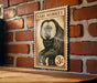 A wooden table with a wooden surface, and a framed illustration of a monkey on a brick wall.