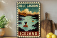 A vintage-style metal sign with the text "BLUE LAGOON ICELAND" and an illustration of a woman swimming in a lake, surrounded by mountains and a cloudy sky.