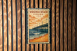 A vintage-style poster of the Virginia Beach pier is displayed on a wooden wall.