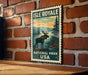 A vintage-style metal sign for Isle Royale National Park in the United States, featuring a moose silhouette against a scenic landscape.