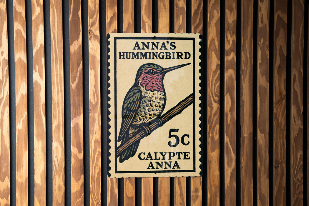 A 5c postage stamp featuring a colorful illustration of a hummingbird, mounted on a wooden wall.