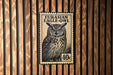 A postage stamp featuring an illustration of an owl, with the text "EURASIAN EAGLE-OWL" printed on it.