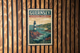 A vintage-style poster of Guernsey Channel Islands hanging on a wooden wall.