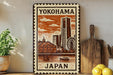 A decorative metal sign with a cityscape and a ferris wheel, featuring the text "Yokohama Japan" on it.