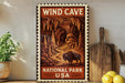 a vintage-style metal sign with the text "WIND CAVE NATIONAL PARK USA" displayed prominently.
