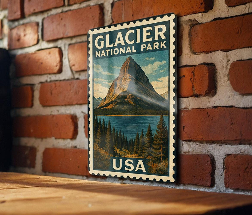 A vintage-style postage stamp featuring a mountain landscape and a lake, mounted on a brick wall.