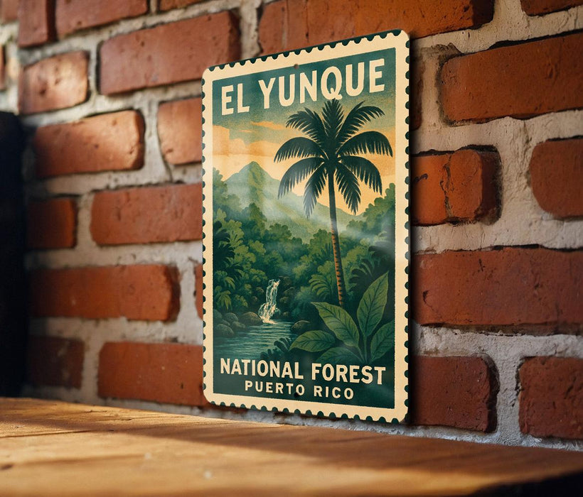 A vintage-style poster of El Yunque National Forest in Puerto Rico, featuring a palm tree and lush greenery, is displayed on a brick wall.