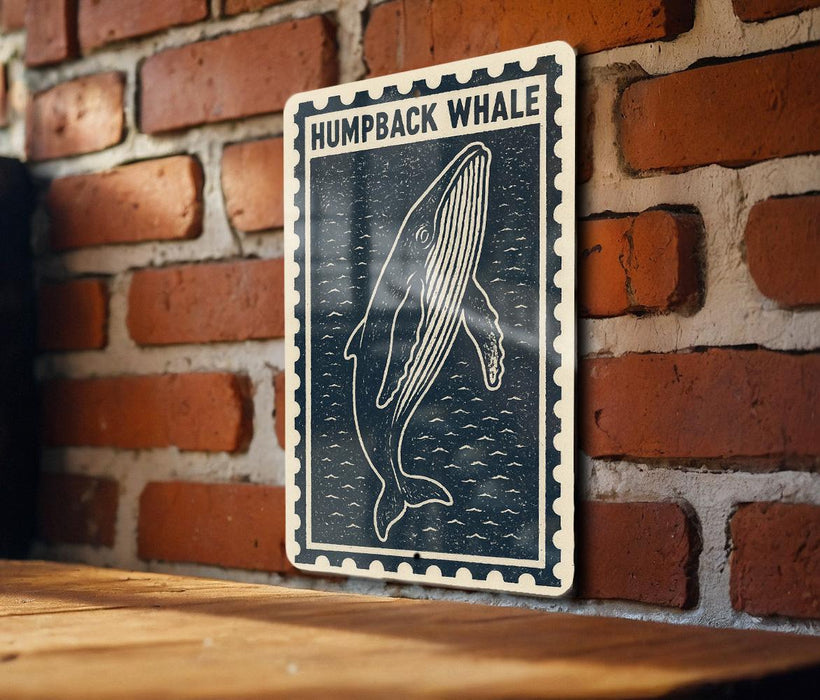 a wooden table with a framed poster of a humpback whale hanging on the wall.