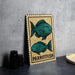 A wooden sign with a postage stamp design featuring two blue parrotfish illustrations.