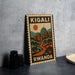 A vintage-style metal sign with the text "KIGALI RWANDA" and an illustration of a cityscape with a sun and mountains.