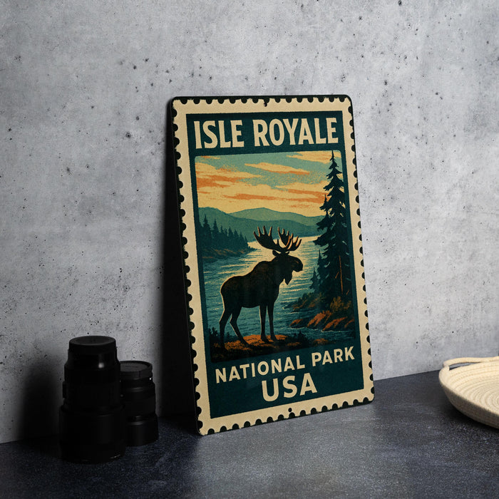 A metal sign with a moose and a scenic landscape, representing Isle Royale National Park in the USA.