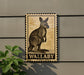 A wall-mounted sign featuring a kangaroo illustration, with the word "WALLABY" below the image.