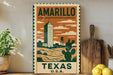 a vintage-style poster of Amarillo, Texas, with a tall building and a cactus in the background, displayed on a wall next to a wooden cutting board and some potted plants.