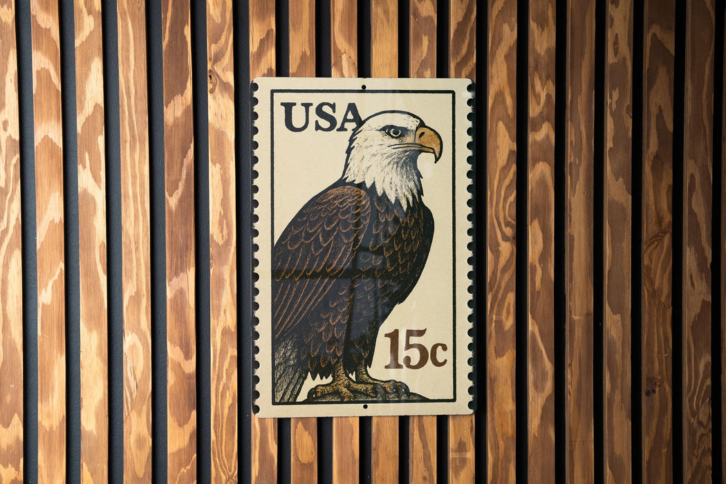 A U.S. postage stamp featuring an eagle, with the text "USA 15c" printed on it.