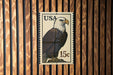 A U.S. postage stamp featuring an eagle, with the text "USA 15c" printed on it.