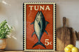 a vintage-style stamp with a fish illustration, placed on a wooden surface next to a wooden cutting board and some lemons.