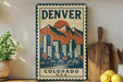 A vintage-style metal sign with a mountain and cityscape design, mounted on a wall next to a wooden cutting board and some potted plants.