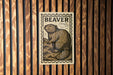 A wooden wall with a beaver illustration on it, which is mounted on the wall.