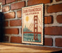 A vintage-style postage stamp featuring the Golden Gate Bridge in San Francisco, California.