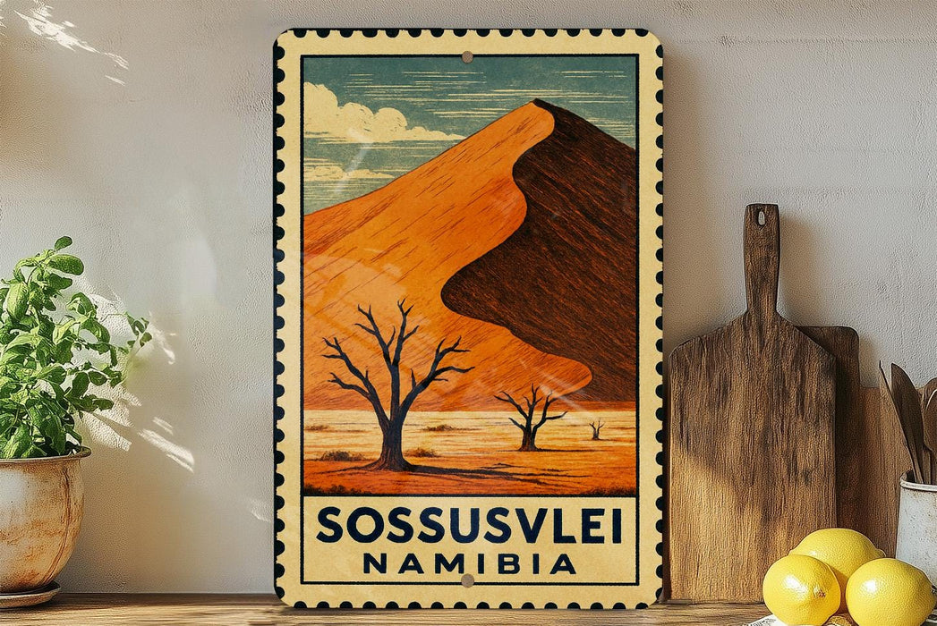 A vintage-style metal sign with a desert landscape and a mountain in the background, featuring the text "SOSSUSVLEI NAMIBIA".
