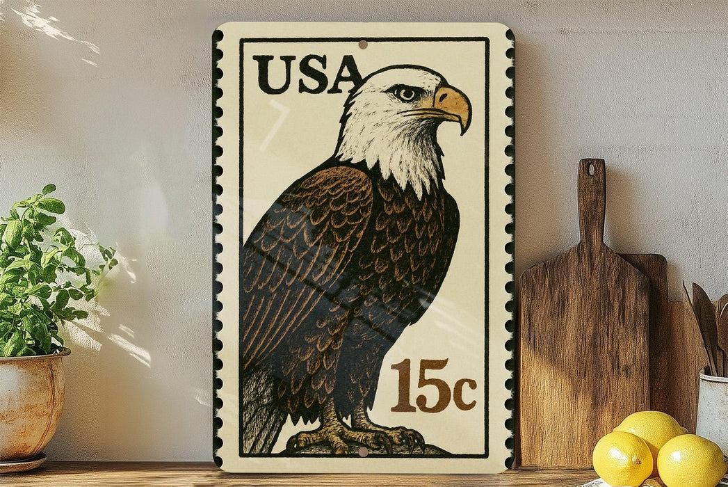 A framed stamp-like artwork depicting a bald eagle, with the text "USA 15c" printed on it, is displayed on a shelf next to a wooden cutting board and some kitchen utensils.