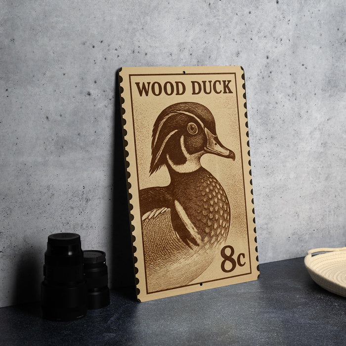 A wooden postcard featuring a wood duck illustration, with the text "WOOD DUCK" and "8c" printed on it.