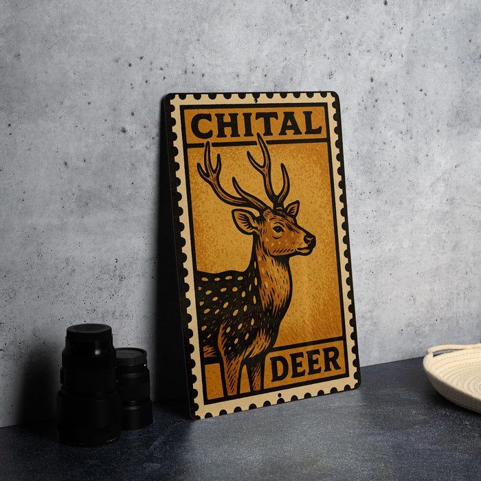 a metal sign with a deer illustration, placed on a table next to some black camera lenses.