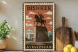 A vintage-style metal sign with the text "BISHKÉK" and "KYRGYZSTAN" on it, along with an illustration of a man on a horse. The sign is displayed on a shelf, with a potted plant, a wooden cutting board, and some lemons nearby.