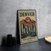 A vintage-style metal sign with the text "DENVER COLORADO U.S.A." and an illustration of a mountain range with a cityscape in the background.