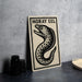 a metal sign with a black and white illustration of a fish, accompanied by the text "MORAY EEL" on a gray background.