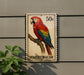 A postage stamp featuring a colorful parrot, specifically a macaw, perched on a branch.