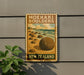 A vintage-style metal sign for Moeraki Bowlers, a famous landmark in New Zealand, featuring a beach scene with large boulders and a cloudy sky.