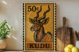 A 50 cent stamp featuring an illustration of a kudu antelope, with a wooden cutting board and lemons in the foreground.