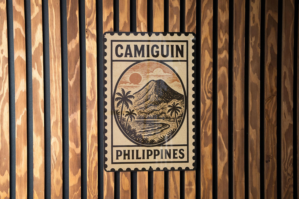 a sign with the word "CAMIGUIN" and "PHILIPPINES" printed on it, mounted on a wooden wall.