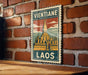A vintage postage stamp featuring a temple in Laos, with the text "VIENTIANE LAOS" prominently displayed.