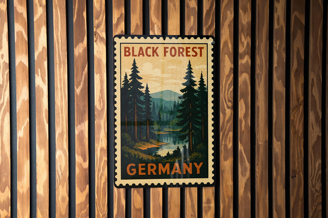 A vintage-style postage stamp depicting a forest scene with pine trees and a river, hanging on a wooden wall.