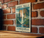 A vintage-style postage stamp depicting Angel Falls, the world's highest uninterrupted waterfall, is displayed on a brick wall.
