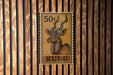 A 50 cent stamp featuring an illustration of a kudu, a type of antelope, on a wooden background.