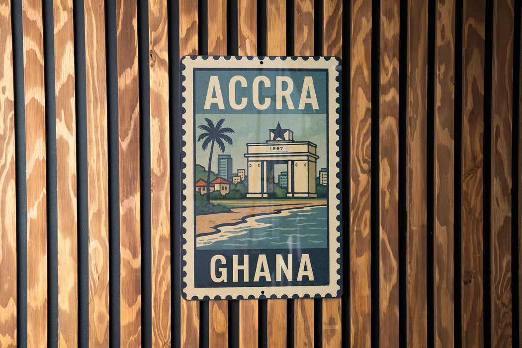 A vintage-style metal sign with the text "ACCRA GHANA" displayed prominently, featuring an illustration of a building and palm trees.