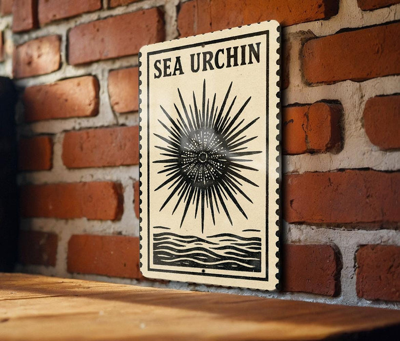 a wooden table with a framed poster or sign hanging on the wall behind it. The poster has a black and white design with a sunburst pattern and the text "SEA URCIN" written on it.