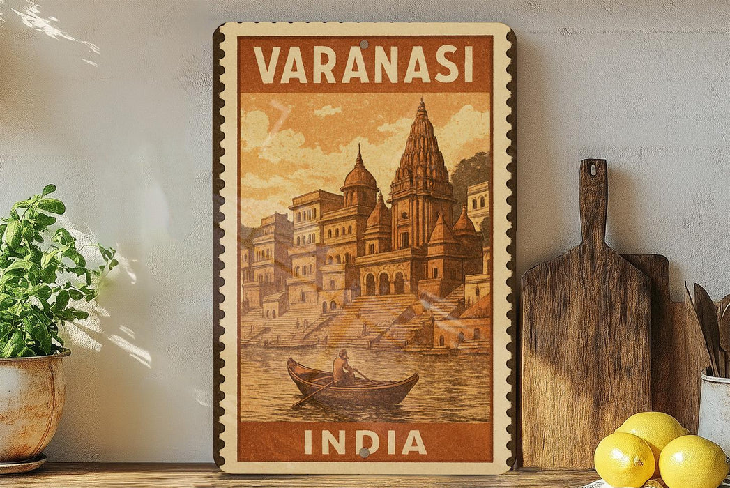 A vintage-style poster of Varanasi, India, featuring a boat on the water and a temple in the background. The poster is framed and displayed on a shelf, with a potted plant and a cutting board nearby.