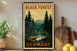 A vintage-style metal sign with a forest scene and mountains, mounted on a wall next to a wooden cutting board and some potted plants.