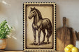 a framed illustration of a horse, which is displayed on a shelf next to a wooden cutting board and some lemons.